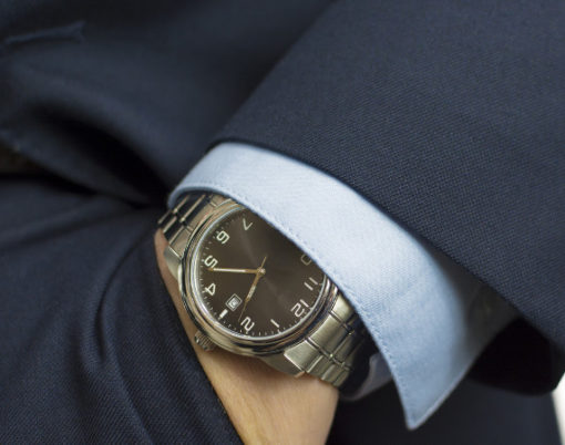 Hand in pocket with wrist watch in a business suit close up