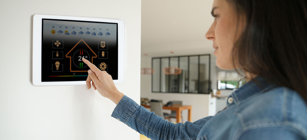 Woman using smart wall home control system