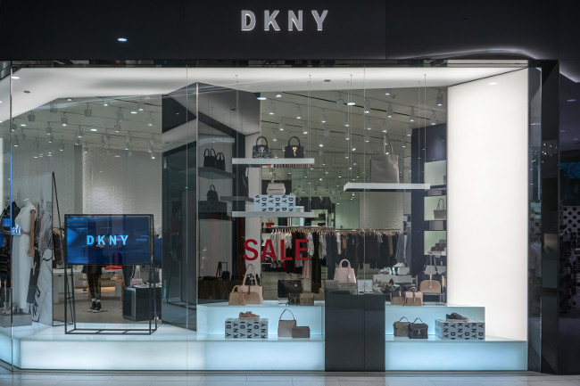 DKNY shop at Emquatier, Bangkok, Thailand, Dec 25, 2018 : Luxury and fashionable brand window display. New collection of clothings and bag showcase at flagship store.