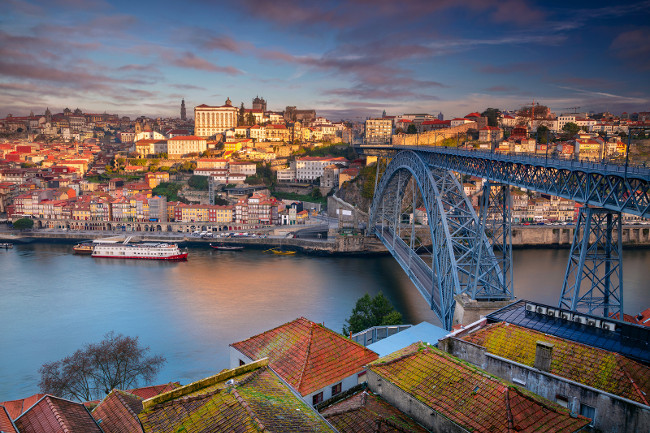 Porto, Portugal. Aerial cityscape image of Porto, Portugal with the Douro River and the Luis I Bridge during sunrise.