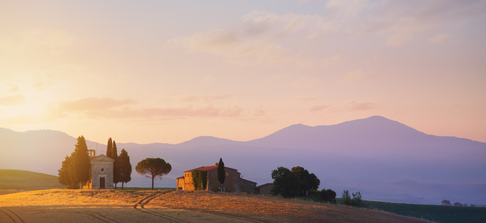 typical Tuscany countryside landscape; sunset over rolling hills and Tuscany farmland