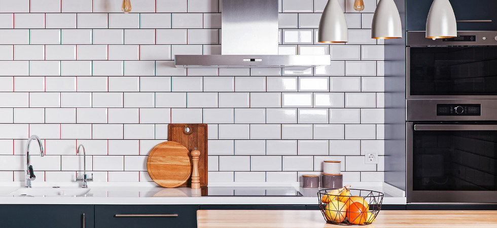 Modern interior. Spacious kitchen with white brick tile wall.