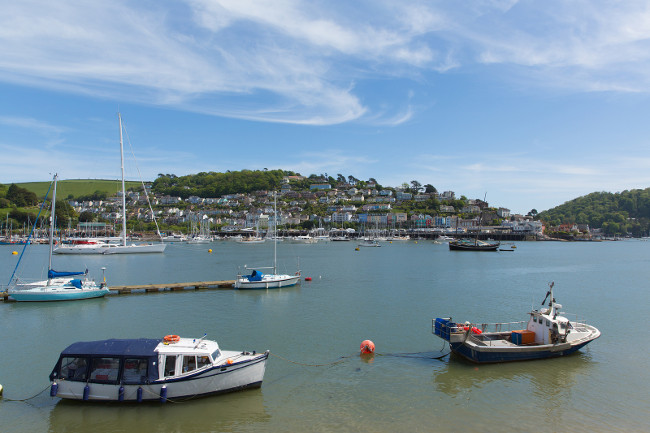 Boats River Dart Dartmouth Devon with houses on the hillside in historic English town