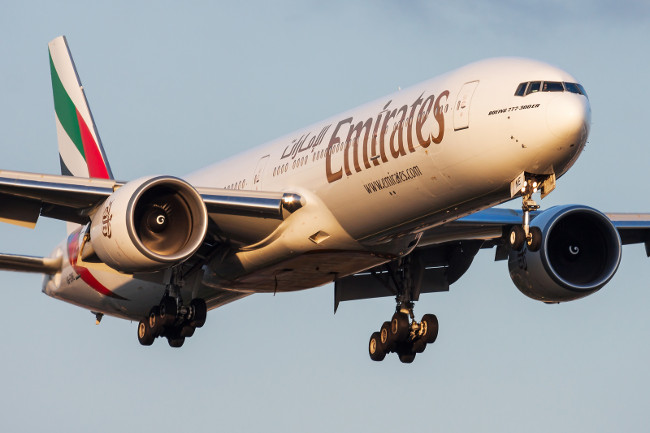 FRANKFURT / GERMANY - AUGUST 20, 2013: Emirates airlines Boeing 777-300ER A6-ENE passenger plane landing at Frankfurt Airport