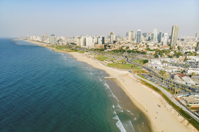 Tel Aviv skyline off the shore of the Mediterranean sea - Panoramic aerial image.