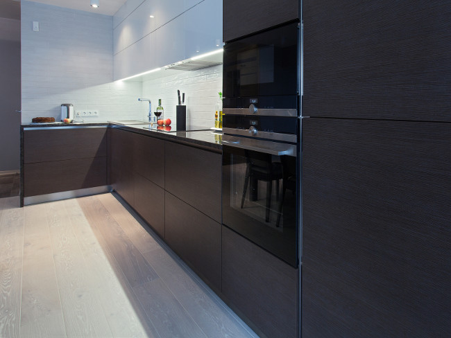 Design interior of a high tech kitchen with dark cupboard