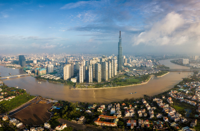 Aerial view of Ho Chi Minh City skyline and skyscrapers in center of heart business at Ho Chi Minh City downtown. Panorama of cityscape on Saigon river in Ho Chi Minh City at Vietnam at sunrise scene