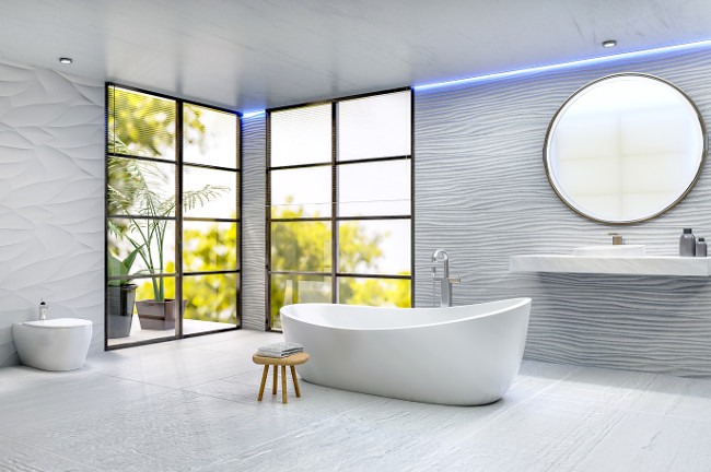 3D illustration of modern bathroom with rounded bathtub. Ceramic sink and round mirror with textured sand dune tiles. Rough white floor tiles. Bath next to windows with trees in background.