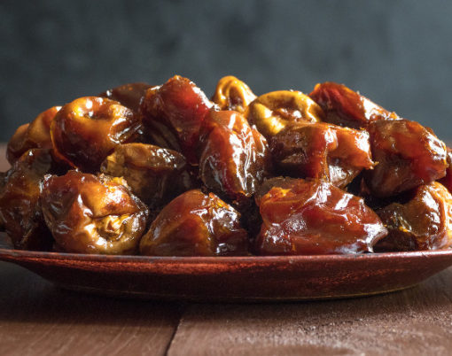 Delicious organic sweet dates in bowl with syrup. Iftar dates.