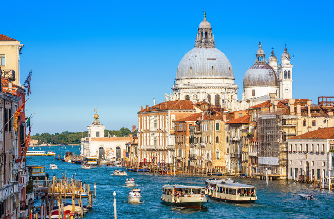 Grand Canal with tourist boats and vaporetto in summer, Venice, Italy. Romantic water trip in Venice. Ancient buildings and cityscape of Venice. Beautiful scenic panorama of the old Venice city.