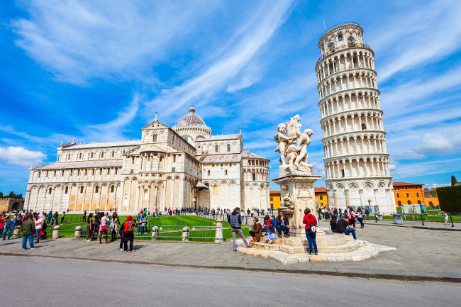 PISA, ITALY - APRIL 06, 2019: Pisa Leaning Tower and Pisa Cathedral at Piazza dei Miracoli or Square of Miracles in Pisa, Italy
