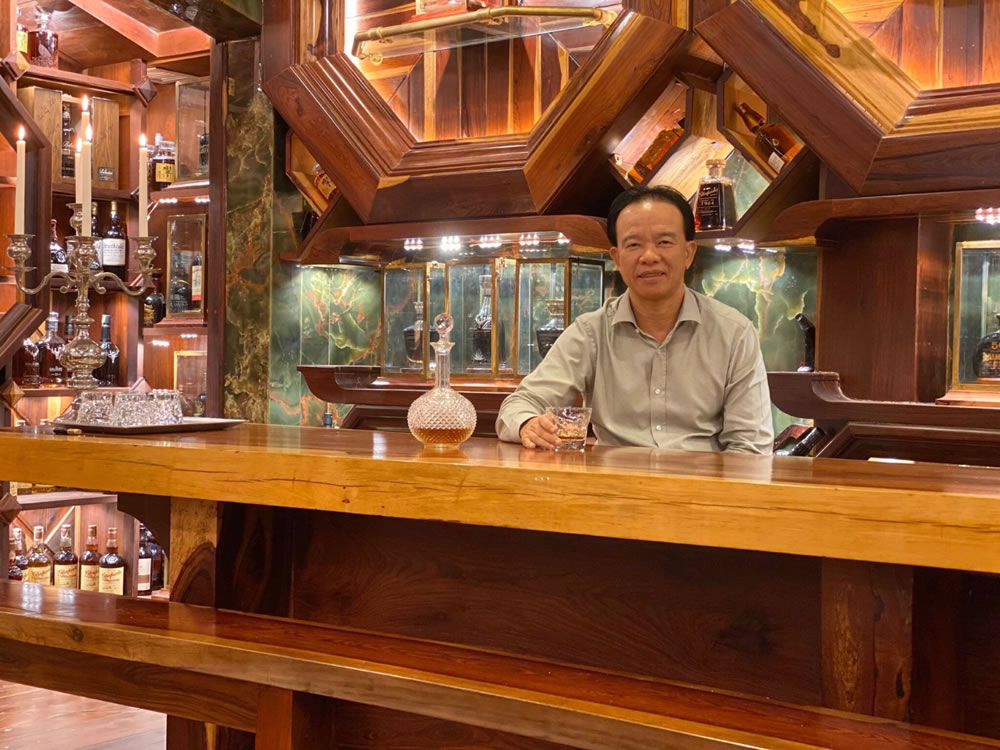 Mr Tuan surrounded by his Guinness World Records whisky collection (2)