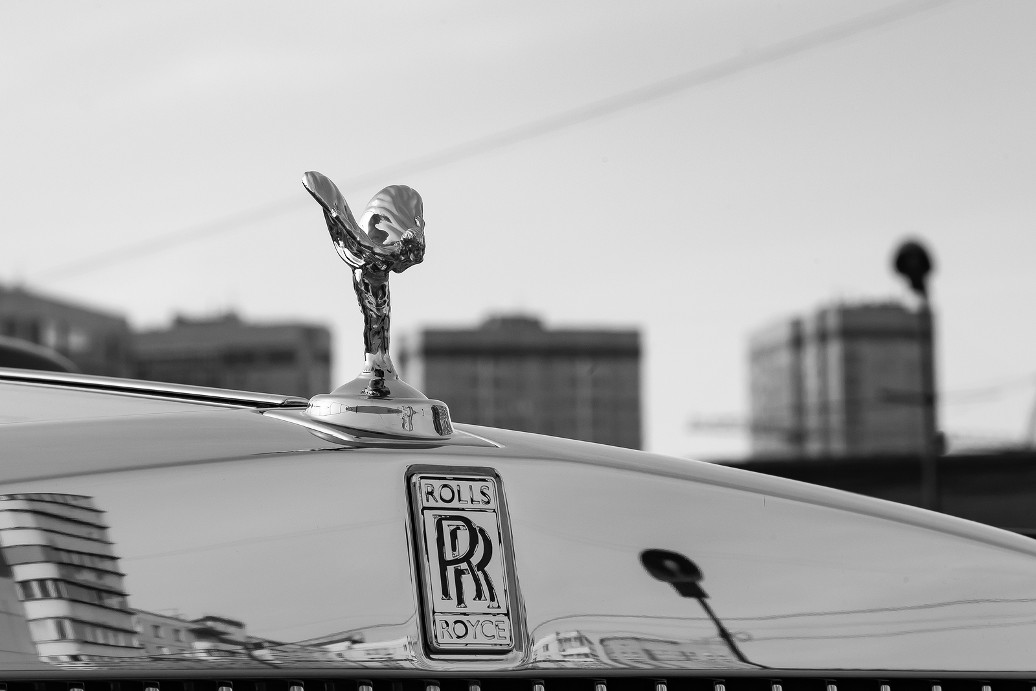 Novosibirsk, Russia - 04.11.2019: Front view of emblem Spirit of Ecstasy of new a very expensive Rolls Royce Phantom car, a long black limousine, model outdoors on parking