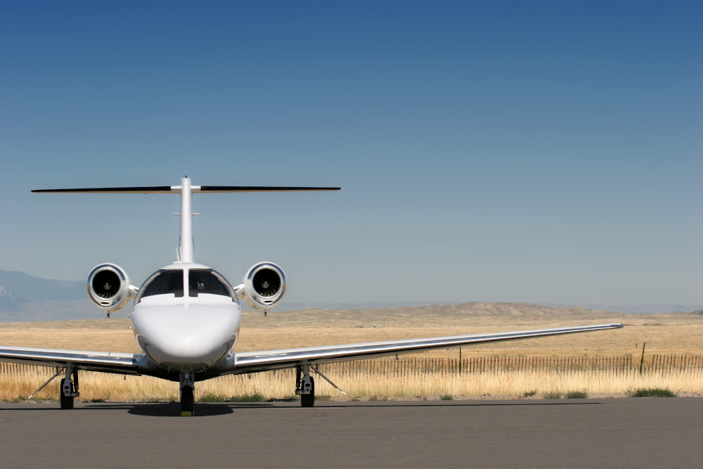 private business jet parked at the airport with copyspace