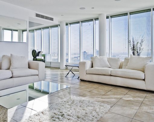 spacious penthouse living room with floor to ceiling windows