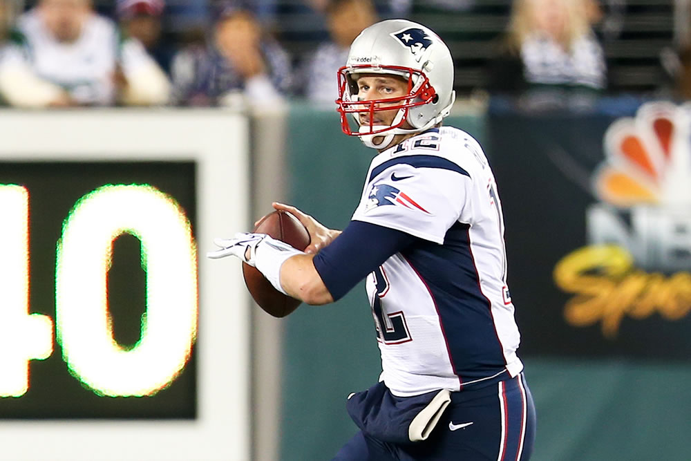 New England Patriots quarterback Tom Brady looks to throw a pass against the New York Jets at MetLife Stadium on November 22, 2012 in East Rutherford, New Jersey