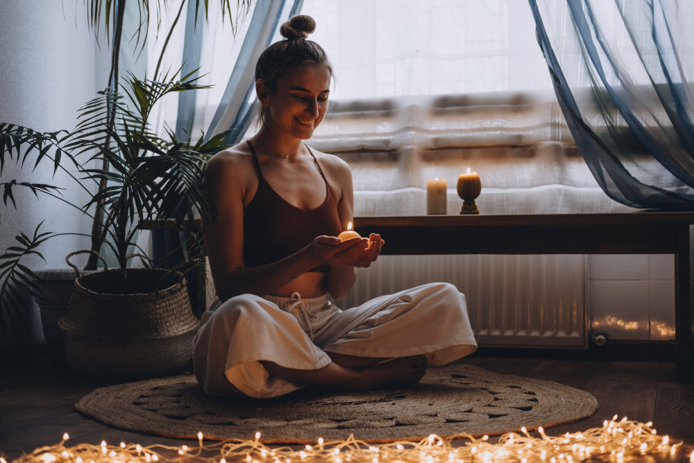 Young woman meditating at home