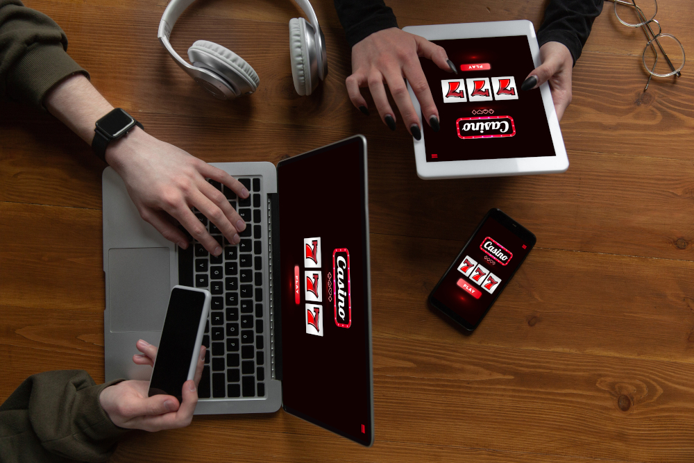 Close up laptop and smartphone screen with mobile app for online casino lottery