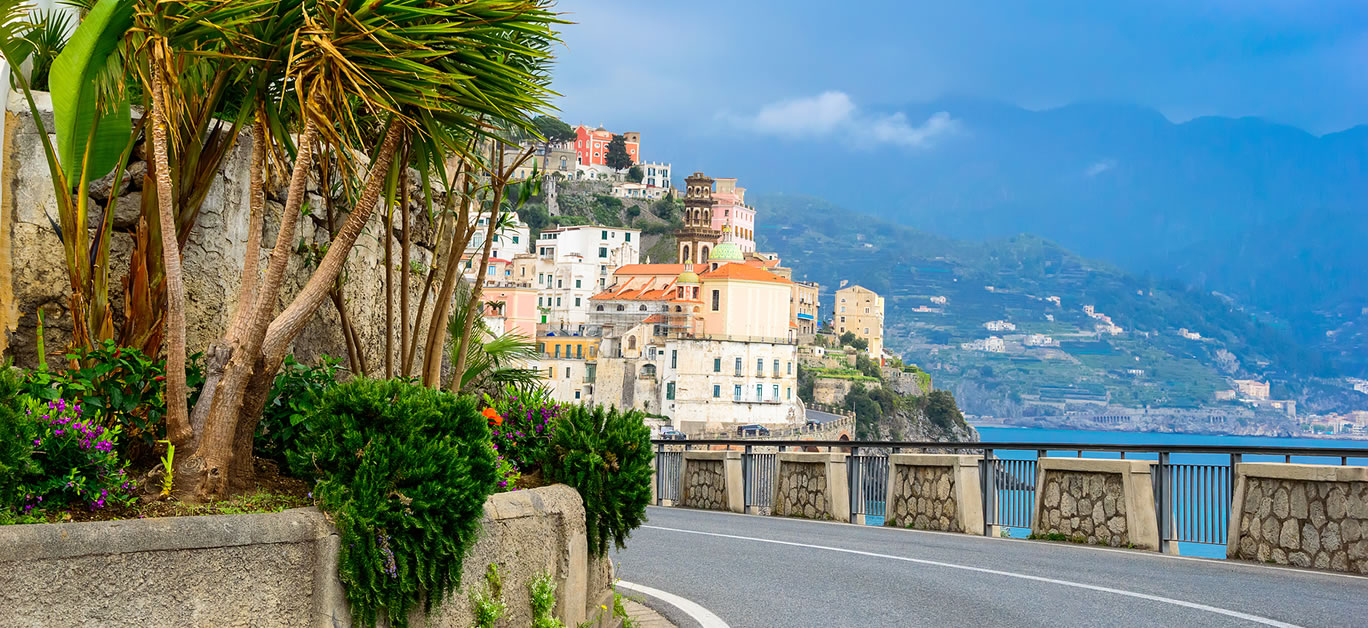 View of the Amalfi coast town, palm trees and road