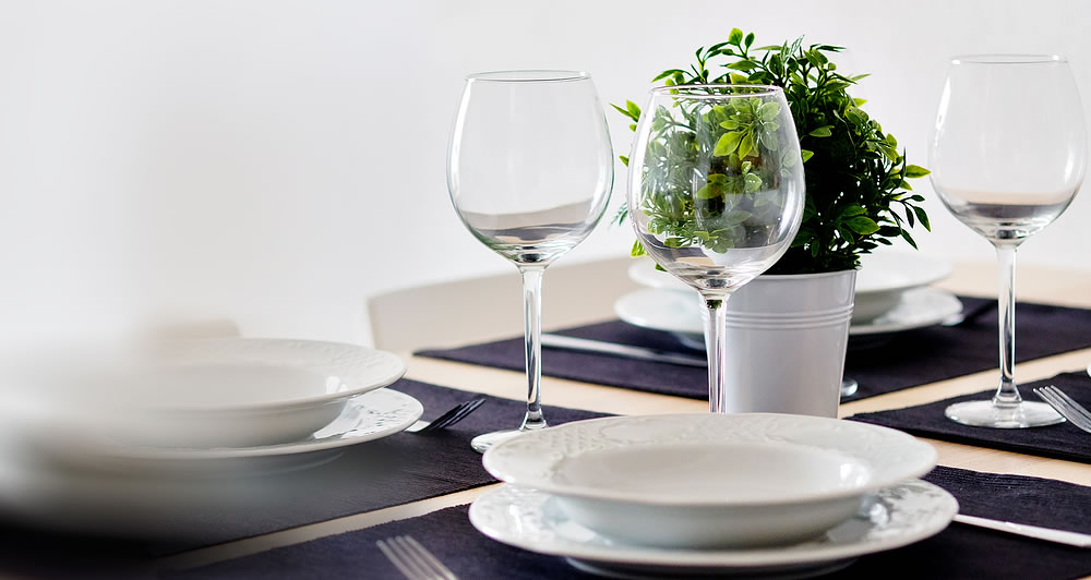 dinner table with plates and wine glasses