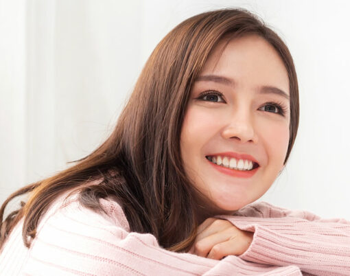 Smiling of cheerful beautiful pretty asian woman clean fresh healthy white skin posing in warm knitted pink clothes