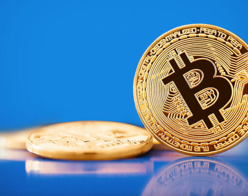 Gold Bitcoin on the blue background. Concept of crypto currency.
