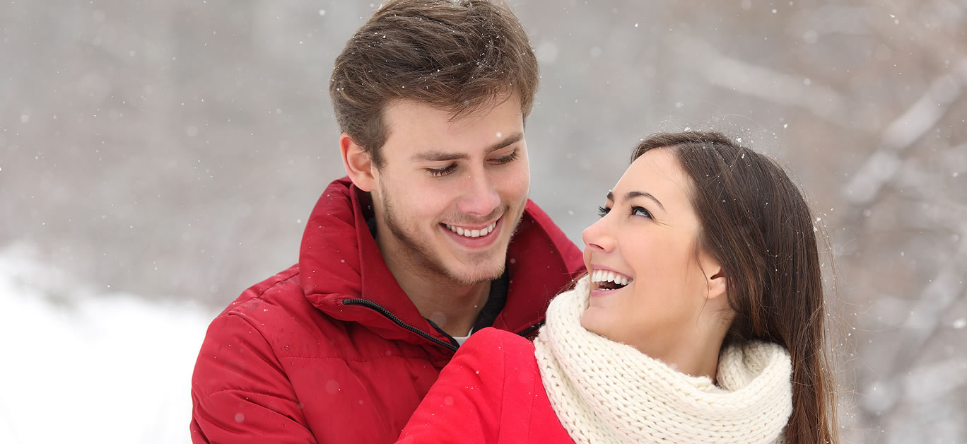 Couple falling in love at first sight in winter outdoors while snowing