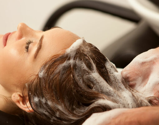 Cropped shot of a woman enjoying hair wash treatment at beauty salon