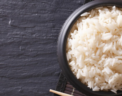 Japanese food: rice in a black bowl and chopsticks. horizontal view from above