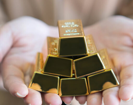 woman holding gold bars