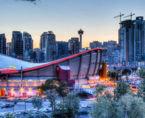 Sunset over Calgary's skyline with the Scotiabank Saddledome in the foreground