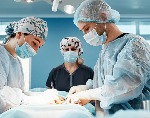 Doctors performing abdominoplasty surgery in the hospital.