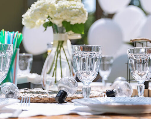 Festive white table setting in the backyard garden. Summer childrens party, garden party, real domestic life.