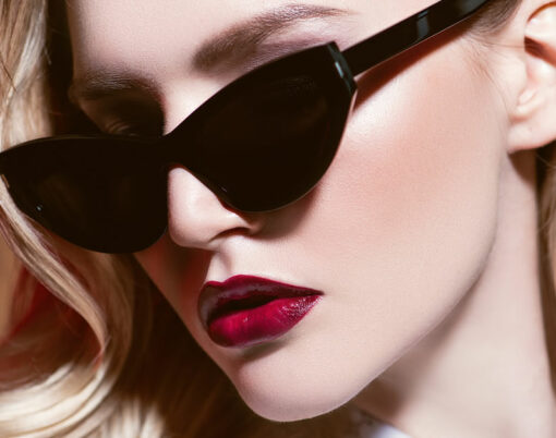 portrait of a beautiful confident lady with blonde hair wearing elegant sunglasses