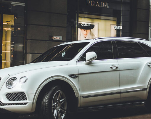 White English Bentley Bentayga SUV parked in the city
