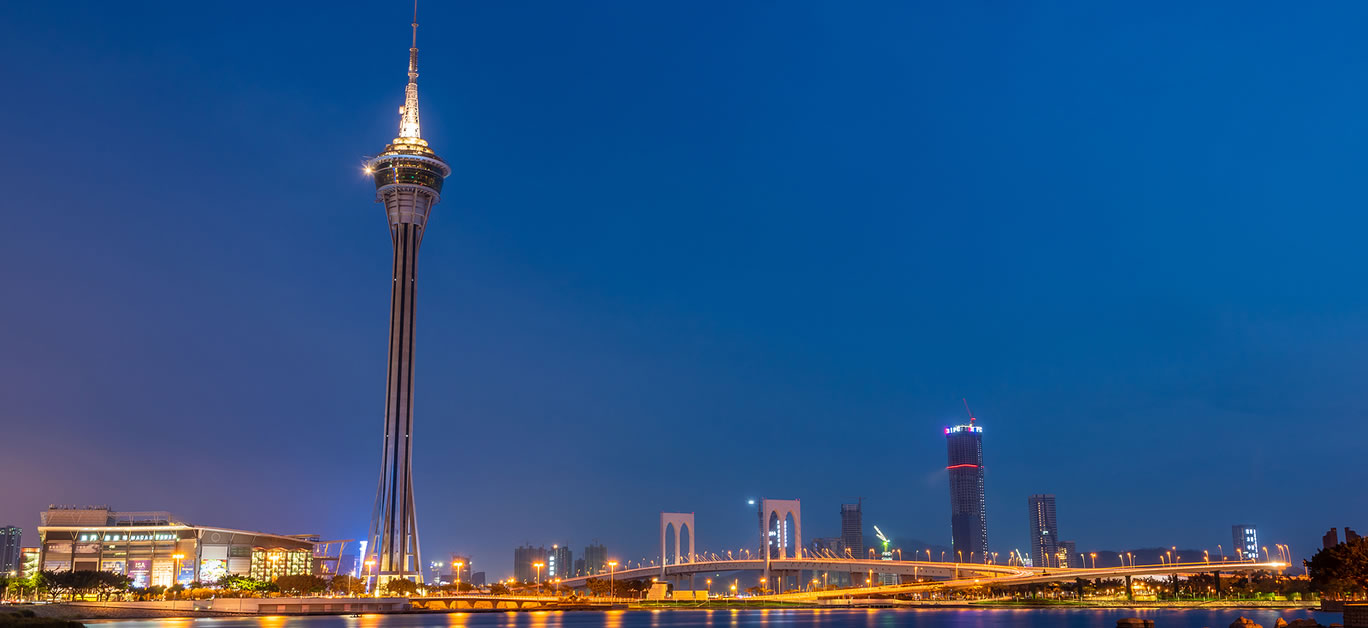 Night view of Macau Tower,famous traveling tower under blue sky near river in Macao, China.