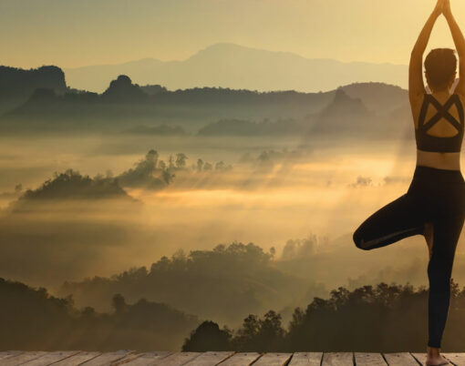 Save Download Preview Young girl doing yoga fitness exercise outdoor in beautiful mountains and morning sunrise