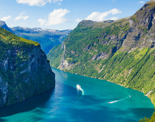 Fjord Geirangerfjord with ferry boats, view from Ornesvingen viewing point, Norway