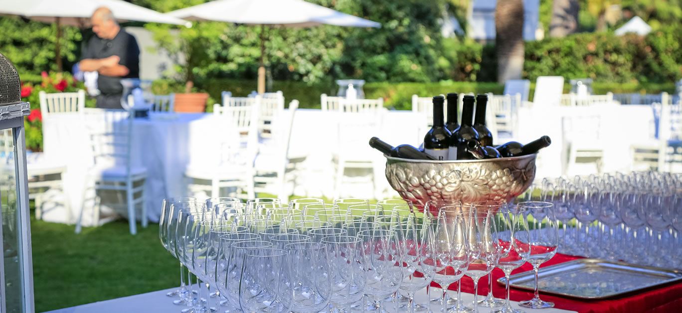 Save Download Preview many crystal wineglasses and red wine in a metal vase on buffet table in garden