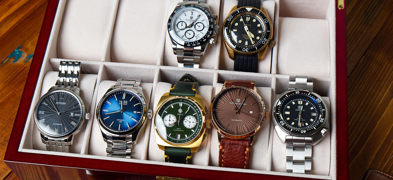 Various Collection of Wrist Watches in the Watches Box on the Wood Table in Bangkok, Thailand.