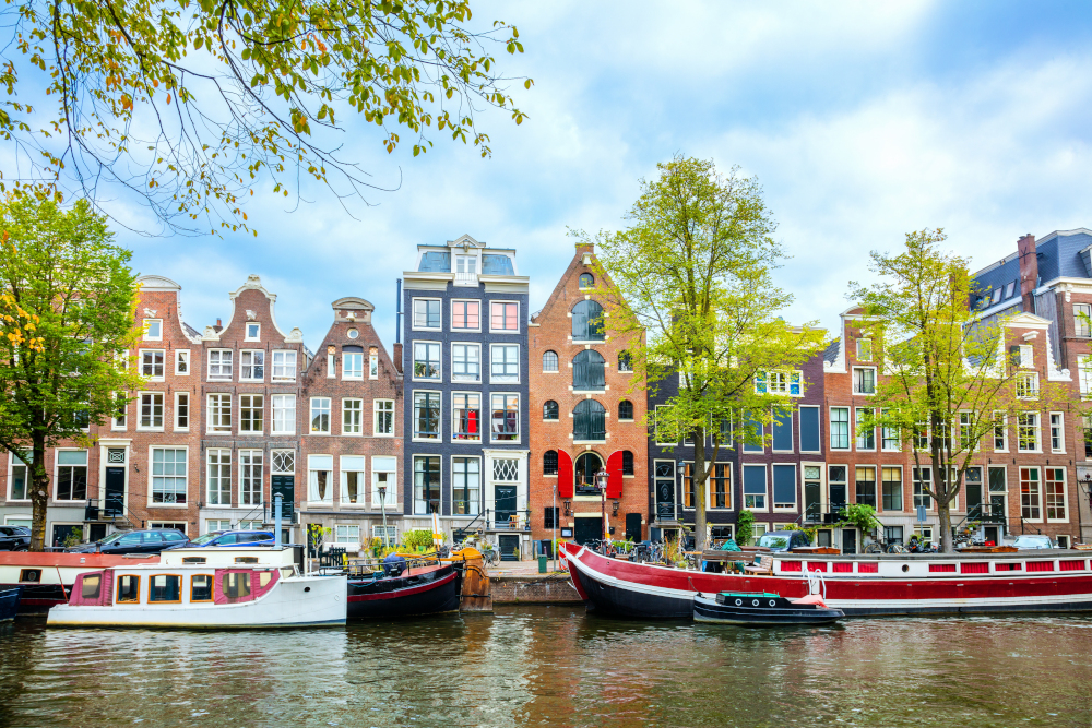 View of the old houses, canal and boats. Famous place in the old center of Amsterdam