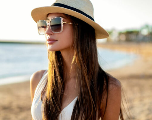 Young beautiful woman enjoying summer vacation, walking at the beach