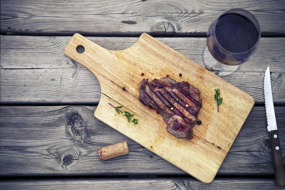 Barbecue grilled beef steak meat with red wine and knife