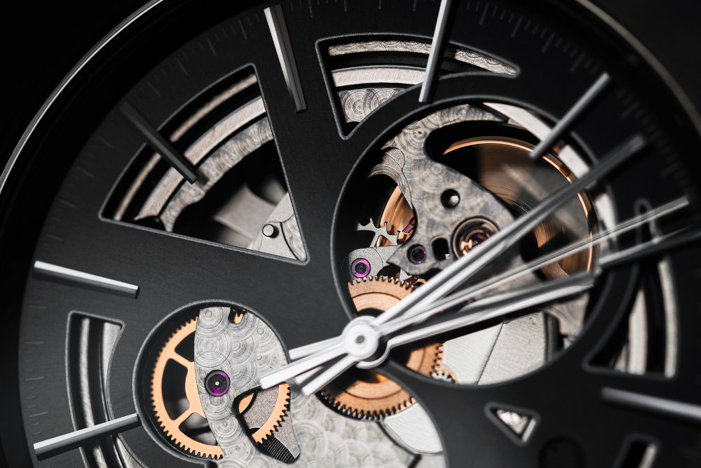 Close-up photo of black deal and hands of automatic mechanical Swiss made skeleton wrist watch