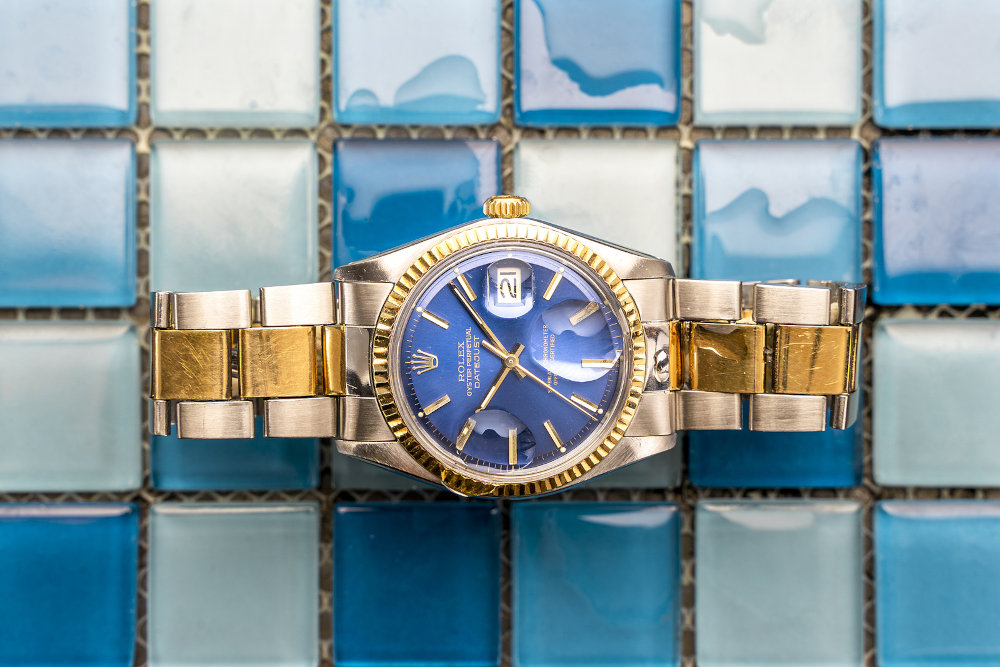 Rolex Oyster Blue watch on tiles background