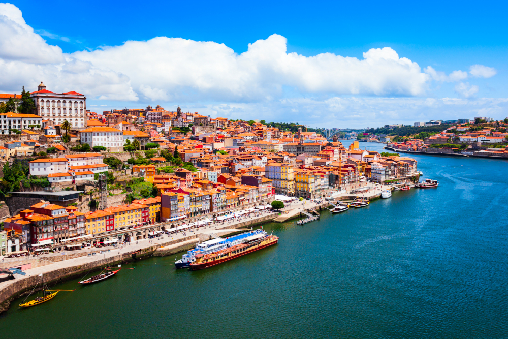 Douro river and local houses with orange roofs in Porto city aerial panoramic view. Porto is the second largest city in Portugal.