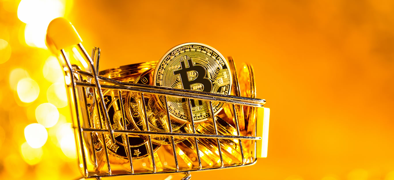 Bitcoin cryptocurrency coins with shopping cart consumer spending theme