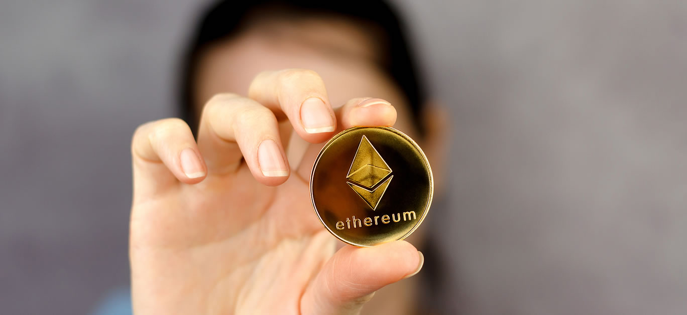 Ethereum coin in a female hand close-up