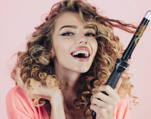 Hairdresser. Smiling curly hair girl holds hairdresser equipment
