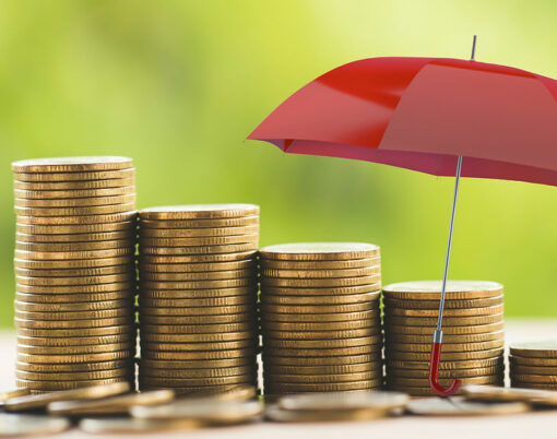 Red umbrella protects rows of increasing coins on table